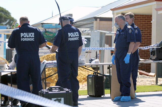 Forensic police officers outside the home where the bodies of two children were found.