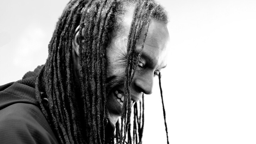 Black and white photo of Ranking Roger laughing