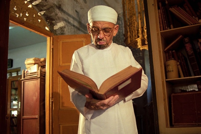 A Parsi priest reads the the Zoroastrian holy book.