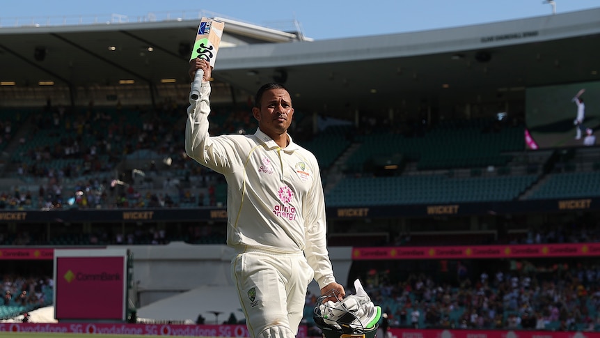 Australia batter Usman Khawaja raises his bat as he walks off the SCG after another Ashes century.