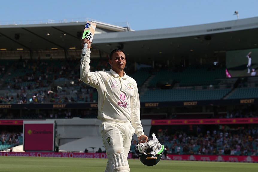 Australia batter Usman Khawaja raises his bat as he walks off the SCG after another Ashes century.