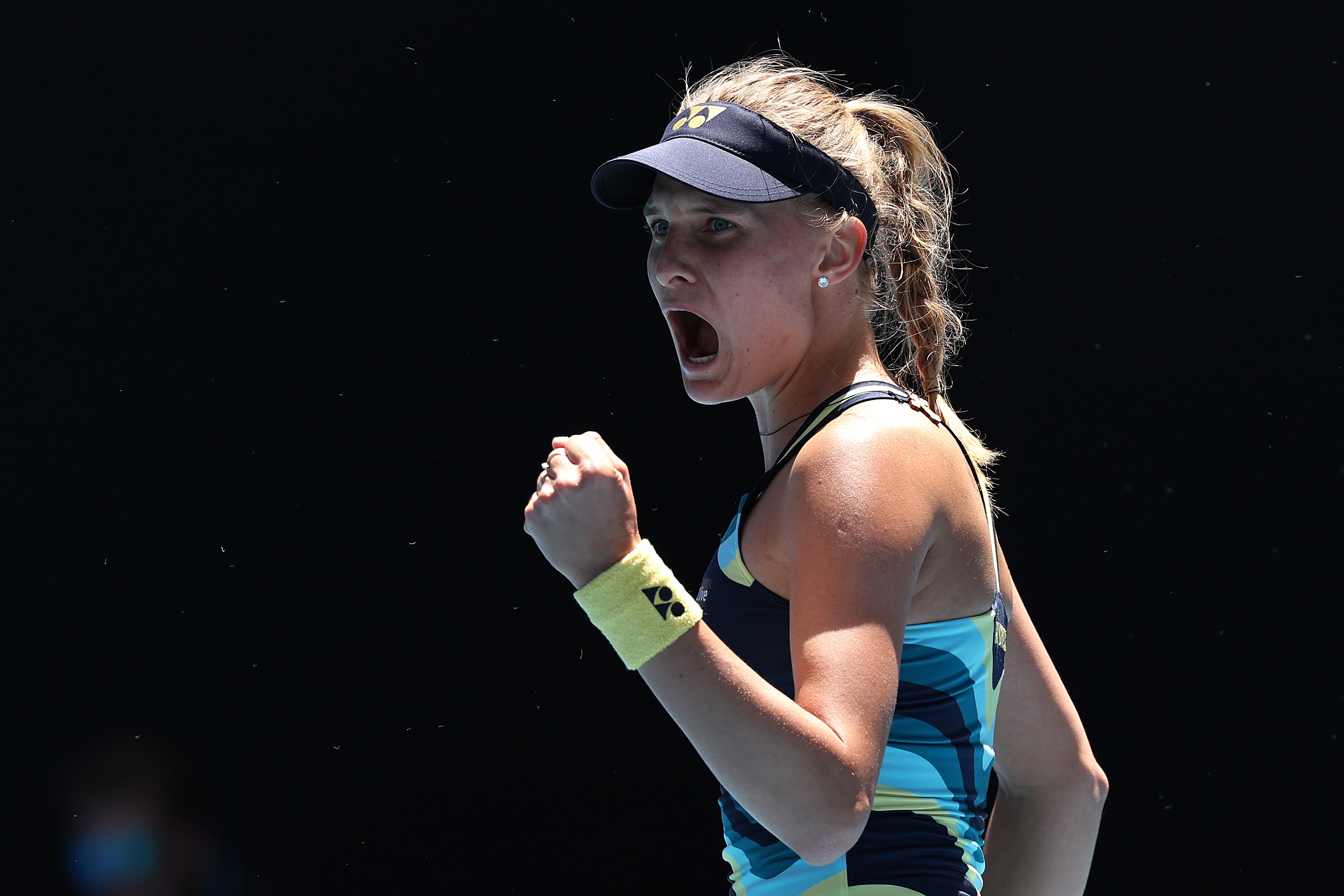 Dayana Yastremska clenches her fist and yells in delight