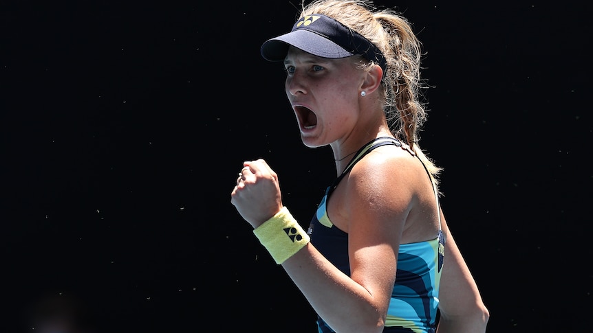 Dayana Yastremska clenches her fist and yells in delight