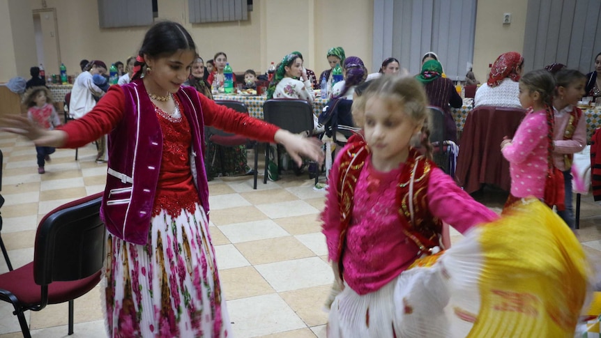 Children dance together at the wedding.