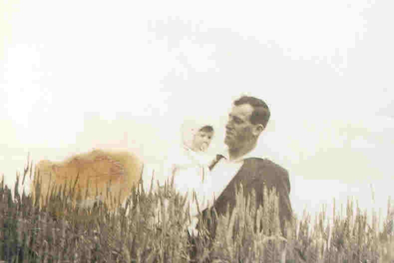 Tom White holds a child, posing with his prize winning crop