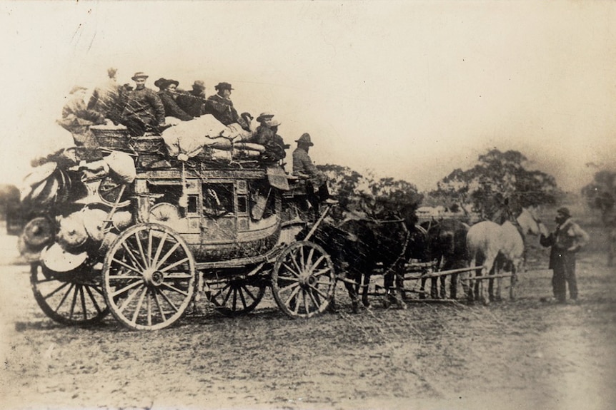 People sitting on horse drawn carriage.