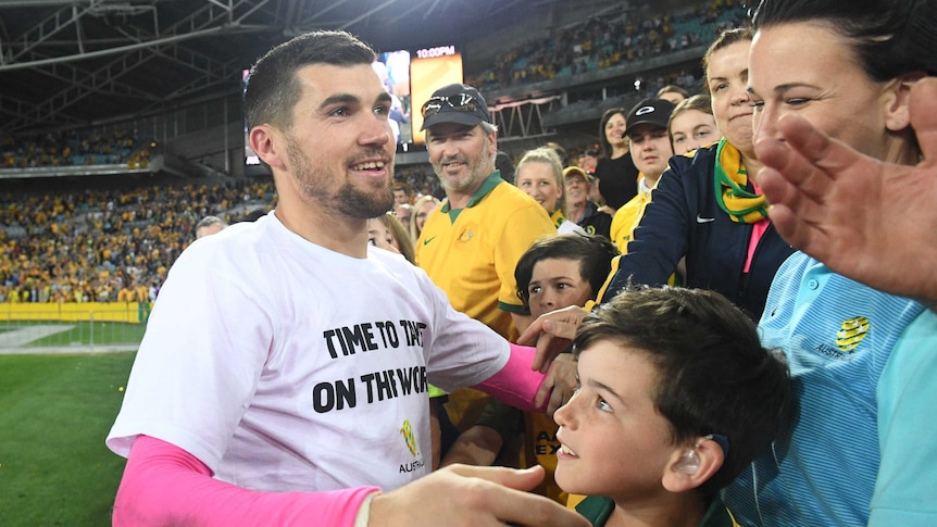 Mat Ryan celebrates with fans after Socceroos qualify for 2018 World Cup