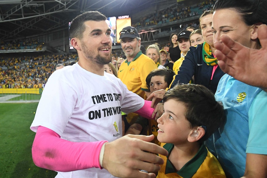 Mat Ryan celebrates with fans after Socceroos qualify for 2018 World Cup