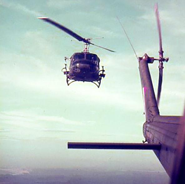 Two helicopters flying over Vietnam during the war