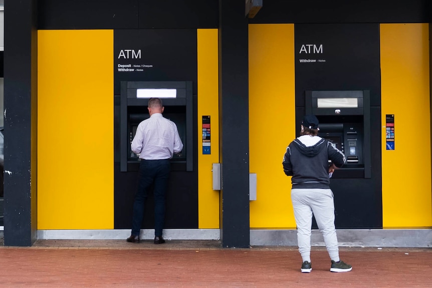 People attempting to use ATMs during the Tasmanian statewide internet outage