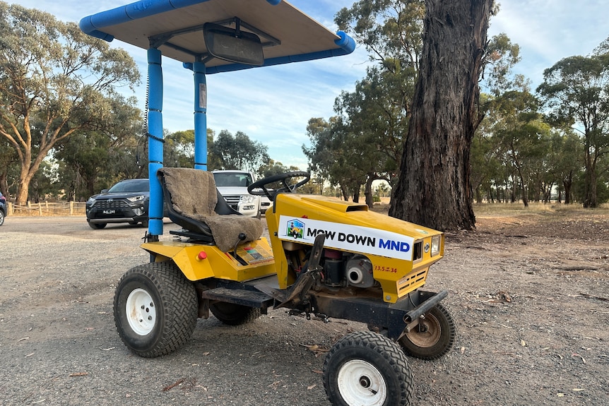 A ride-on lawnmower with a sticker on it that says "Mow down MND".