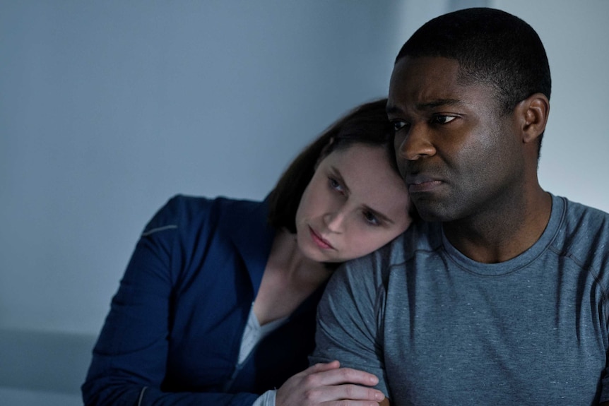 Actor Felicity Jones leans on David Oyelowo in the sci-fi movie The Midnight Sky