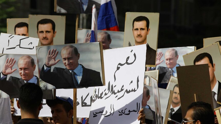 Several hundred people march near the Russian embassy in Damascus, Syria just before two rockets struck the compound