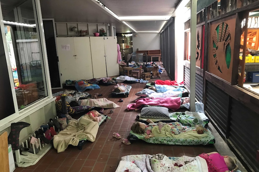 Children sleeping on the covered patio at a childcare centre.