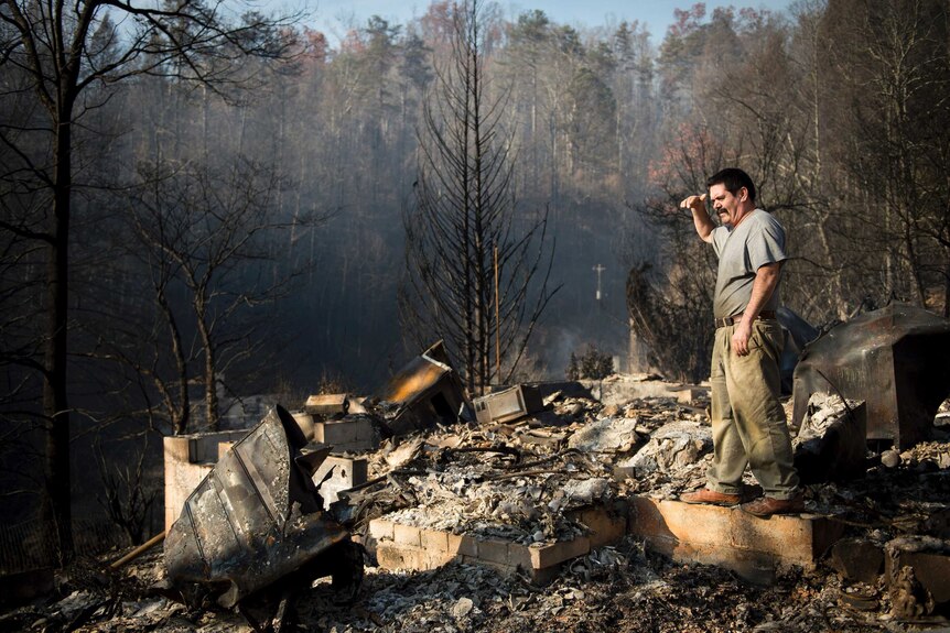 Man looks over destroyed home after Tennessee fires
