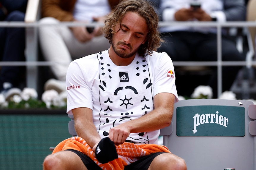 Stefanos Tsitsipas pulls on his wristband.