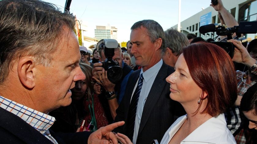 Prime Minister Julia Gillard is confronted by former Labor leader Mark Latham at Brisbane's Ekka sho