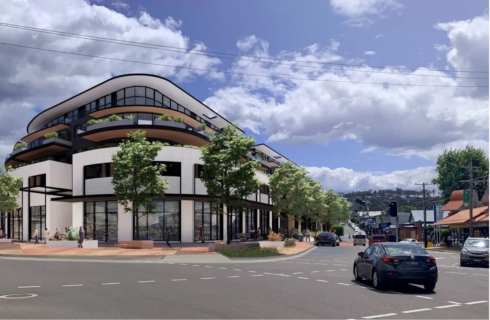 An artist's impression of a 5-storey apartment block on the corner of an intersection. 