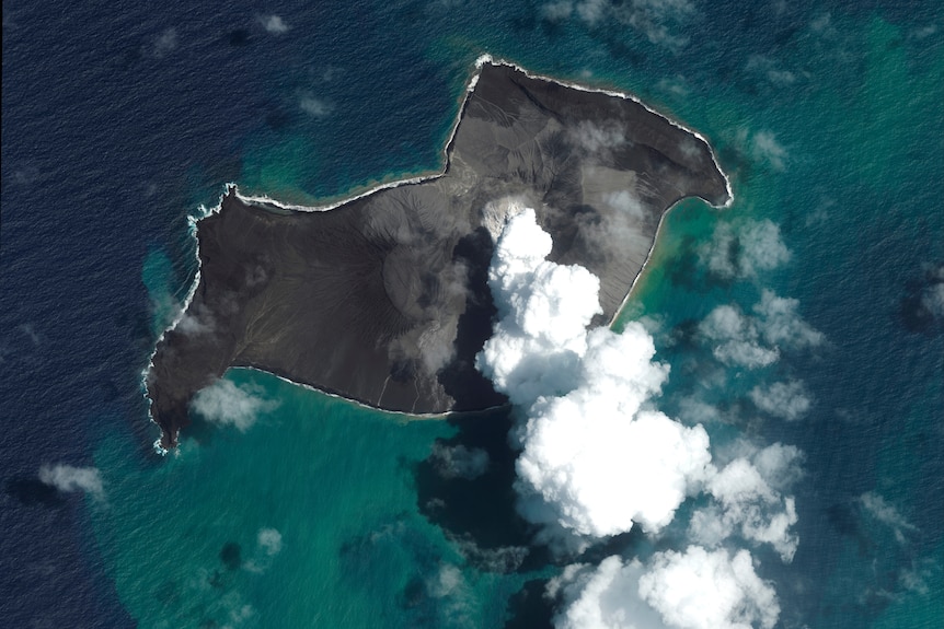 Aerial view of volcano with smoke.