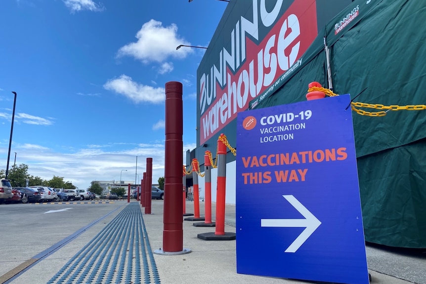 Bunnings store exterior with sign pointing to vaccination clinic
