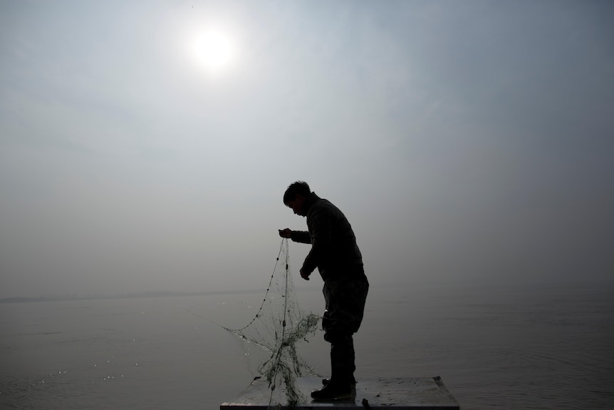 A man standing on the bank of the Yellow River in Zhengzhou 