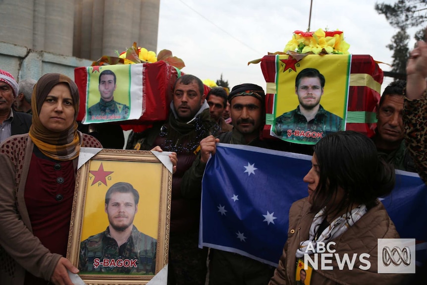 Kurdish fighters carry coffins, pictures and Australian flag