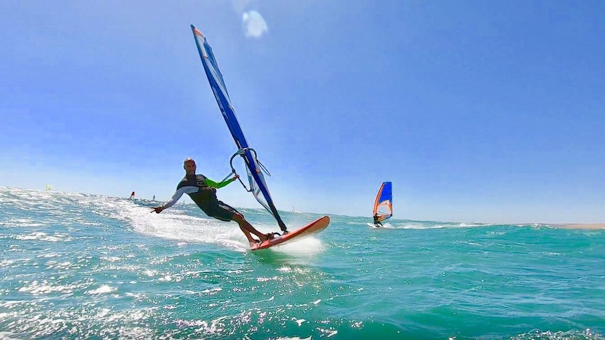 A windsurfer in the water at Coronation Beach, near Geraldton, in WA's Midwest.