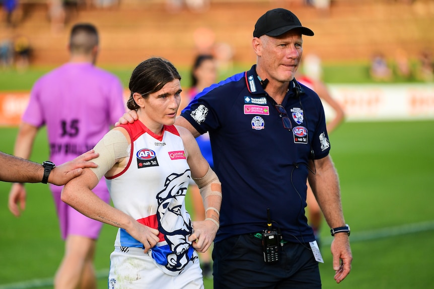 Kirsten McLeod is comforted by coach Nathan Burke who puts his hand on her shoulder