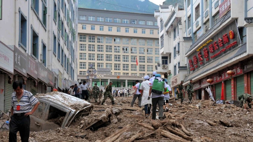 Search: rescuers trawl through debris to help survivors of the landslide that hit Zhouqu county