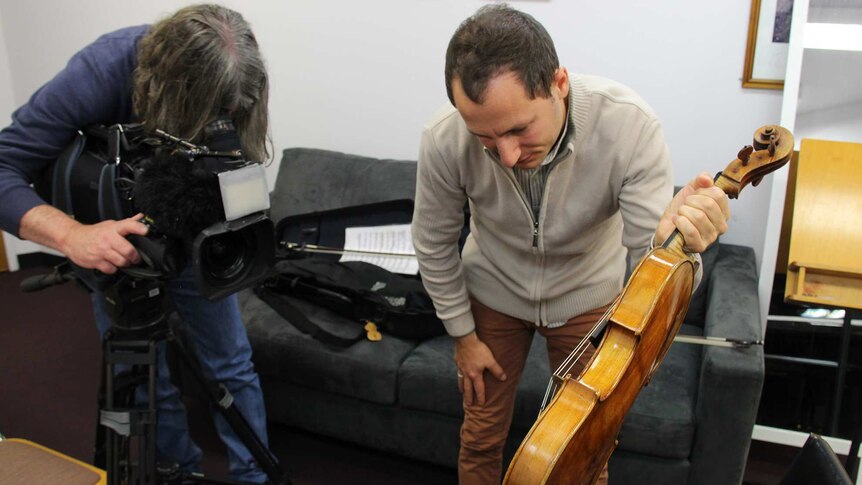 Antoine Tamestit shows the viola to an ABC cameraman.