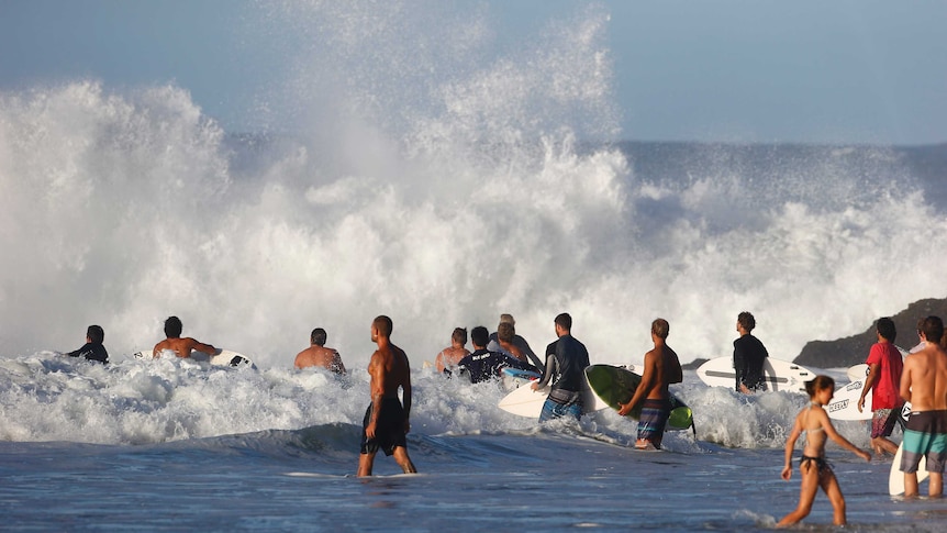 Surfers attempt to enter the rough water courtesy of ex-Cyclone Winston at Snapper Rocks on the Gold Coast on February 26.
