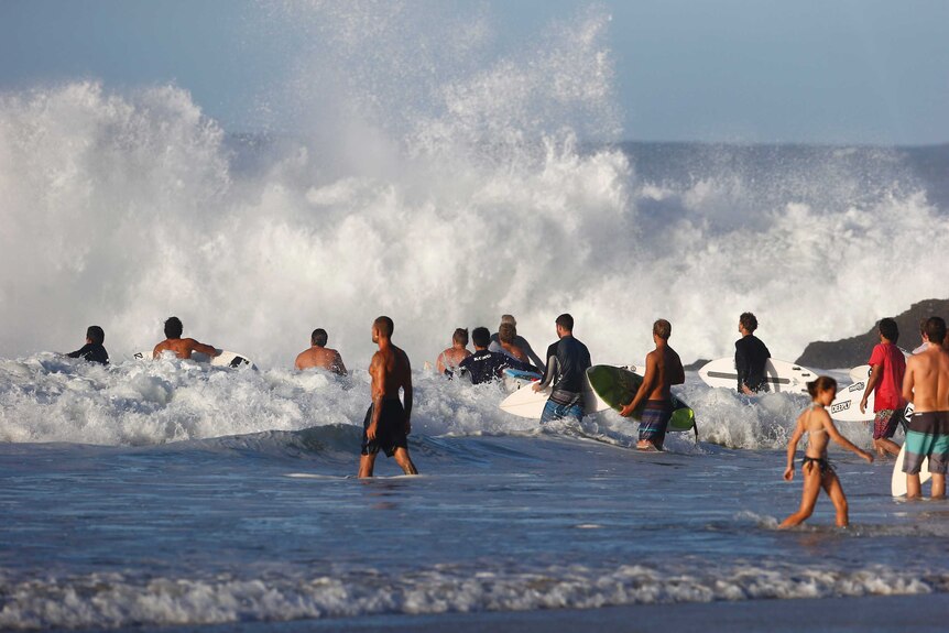 Surfers attempt to enter the rough water courtesy of ex-Cyclone Winston at Snapper Rocks on the Gold Coast on February 26.