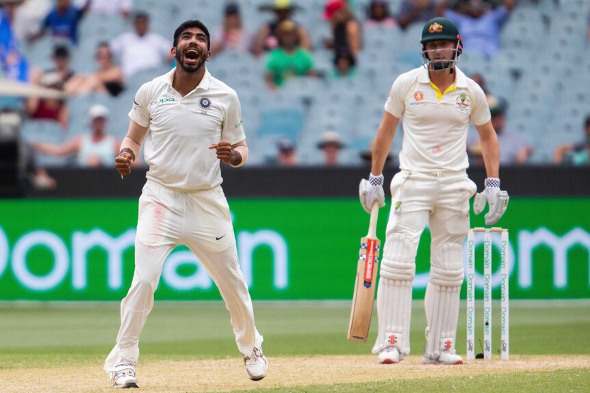 Jasprit Bumrah looks upwards and celebrates the wicket of Shaun Marsh, as the batsman looks on dejectedly