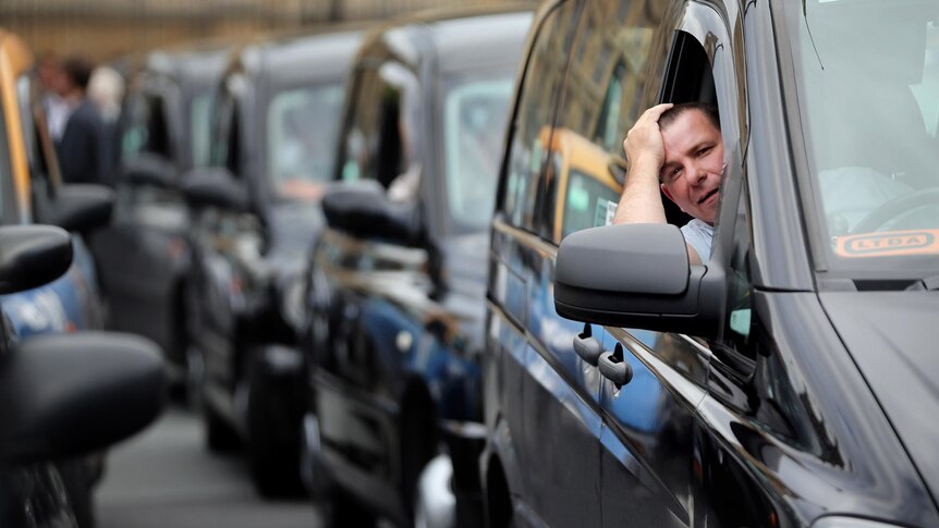 Taxi drivers demonstrate in London over a ban on taxis being able to use Olympic traffic lanes.