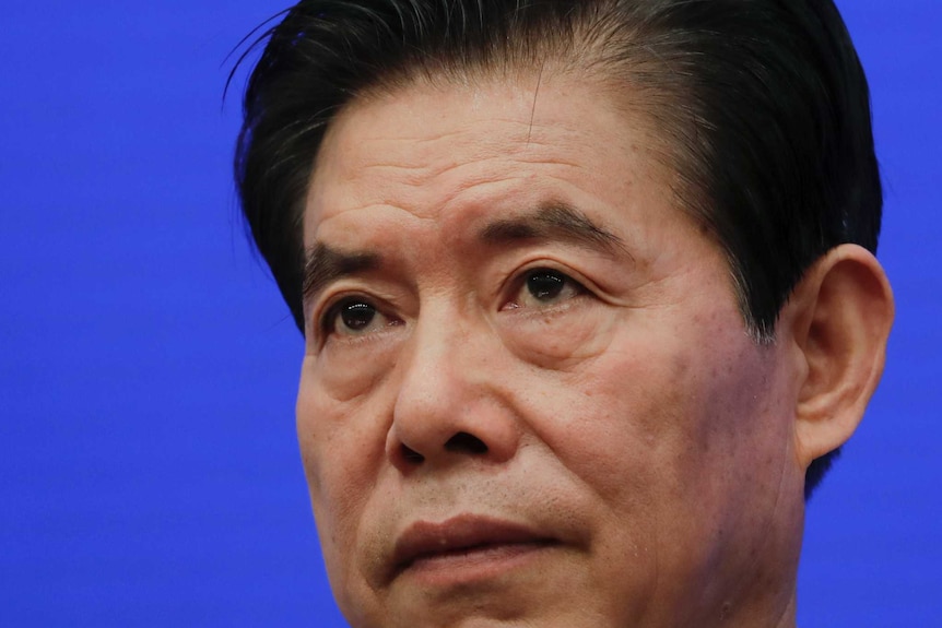 Chinese Commerce Minister Zhong Shan pauses during a press conference.