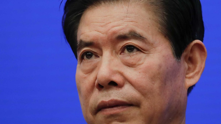 Chinese Commerce Minister Zhong Shan pauses during a press conference.