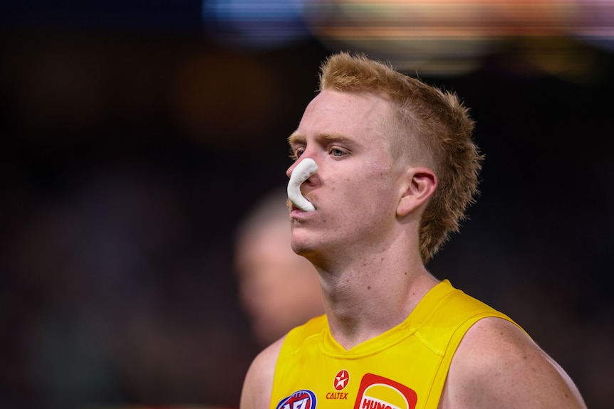 Ryan Maric walks off Adelaide Oval with his mouthguard hanging out of his mouth.