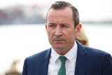 A head and shoulders shot of Mark McGowan looking grim while talking at a media conference. 
