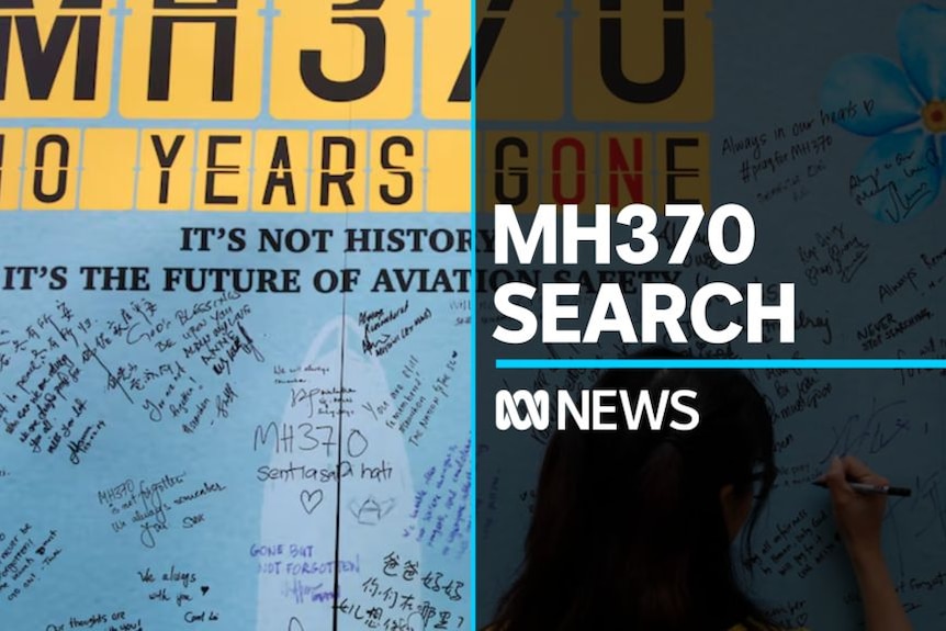 MH370 Search: Woman signs condolence wall for missing air plane.