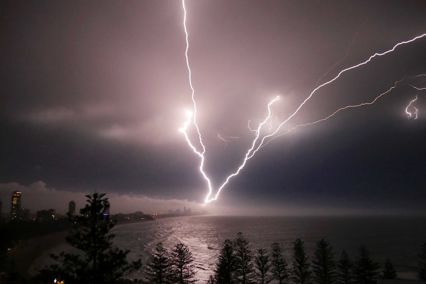 Multiple lightning strikes looking over the beach towards the Gold Coast