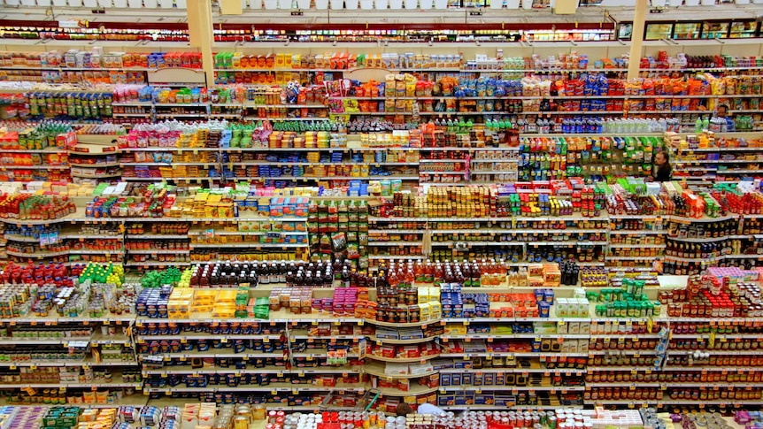 Supermarket shelves lines with colourful products