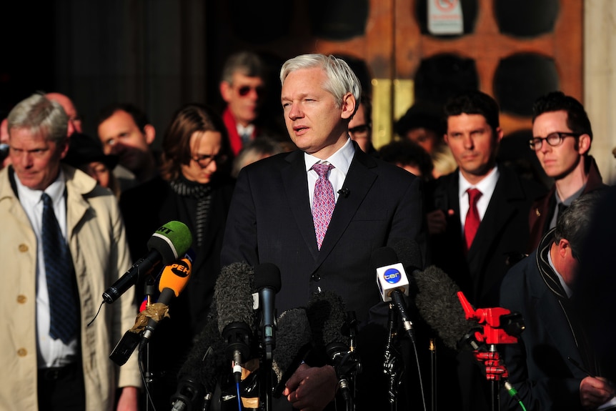 WikiLeaks founder Julian Assange speaks to the media after leaving the High Court in London on December 5