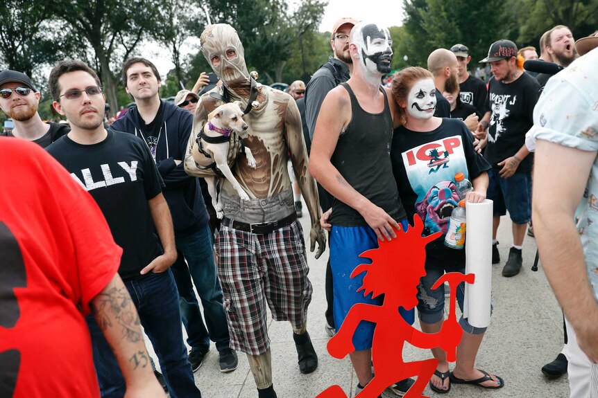 Fans donning clown like face makeup walk washington streets