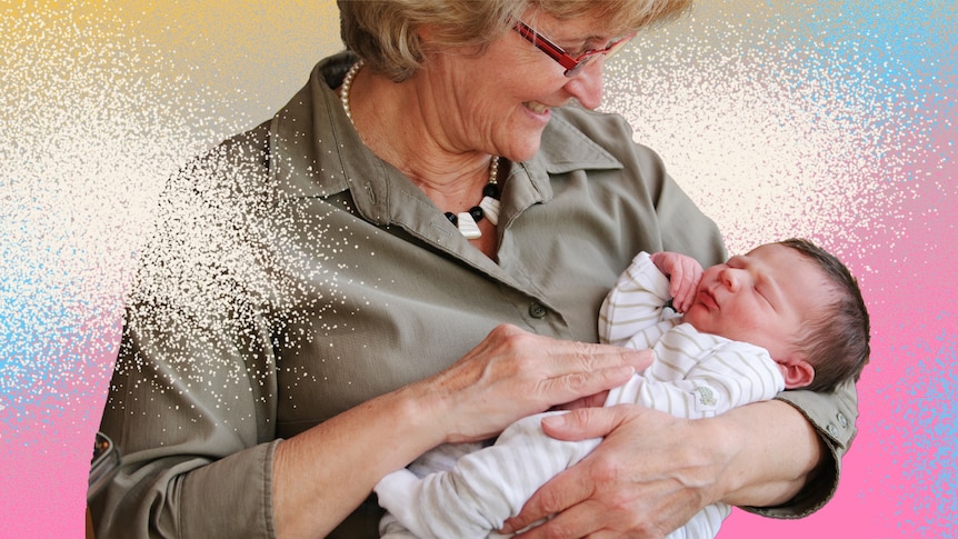 Older woman holds newborn baby in her arms