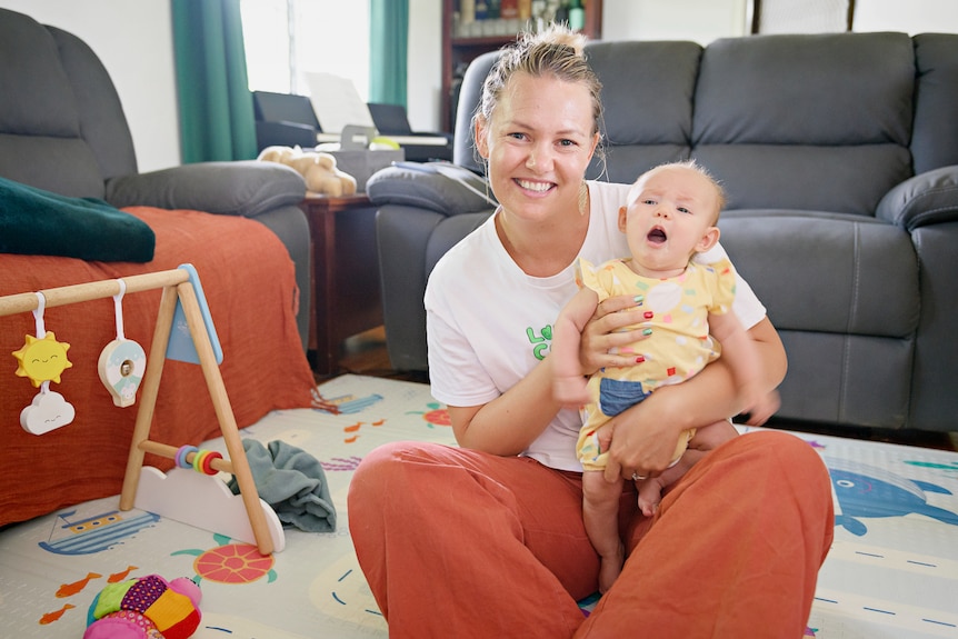 A portrait of Darwin mum Amy Hetherington and her baby.