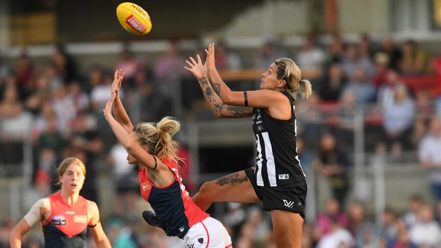 Collingwood player Moana Hope marks over Brooke Patterson of Melbourne during an AFLW game.