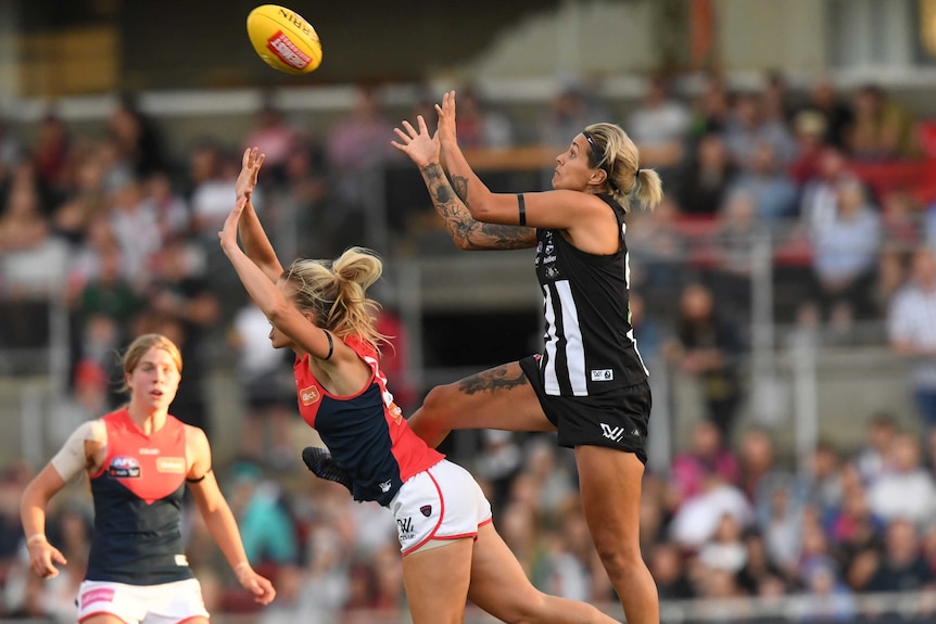 Collingwood player Moana Hope marks over Brooke Patterson of Melbourne during an AFLW game.