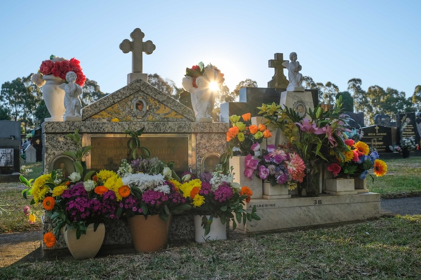 A Russian grave stone, with the sunset behind.