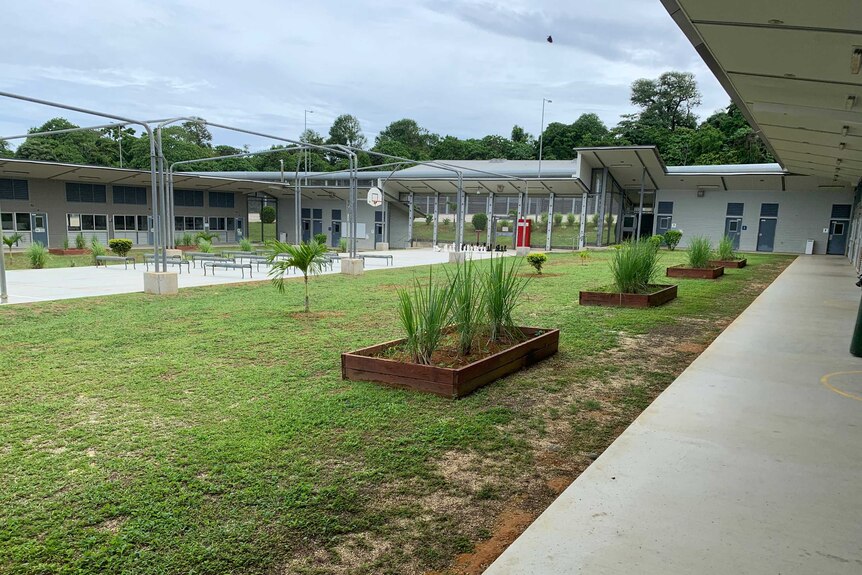 An outdoor area, including grass, basketball court and giant chess, in a facility used for quarantine on Christmas Island.