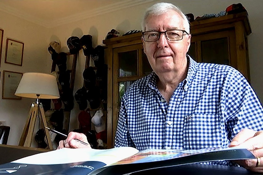 Dr Geoff Newcombe sitting at a desk in his office.